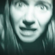 A black-and-white image of a terrified woman in found-footage horror movie Paranormal Activity: Next of Kin.